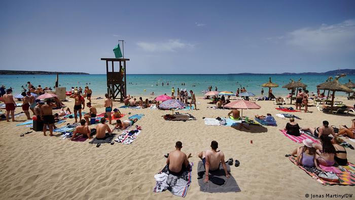 People sit on the beach Playa de Palma