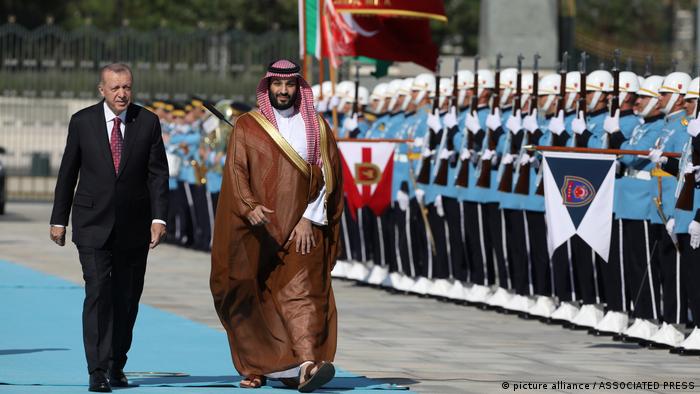Turkish President Recep Tayyip Erdogan, left, and Saudi Crown Prince Mohammed bin Salman review a military honour guard during a welcome ceremony, in Ankara