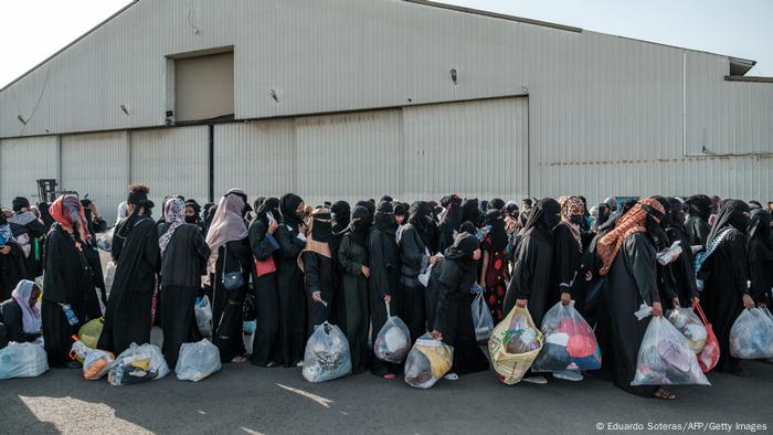 Hundreds of people wait in line for registration after their arrival in Ethiopia from Saudi Arabia