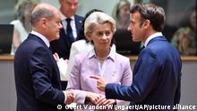 German Chancellor Olaf Scholz, left, speaks with European Commission President Ursula von der Leyen, center, and French President Emmanuel Macron during a round table meeting at an EU summit in Brussels, Thursday, June 23, 2022. European Union leaders are expected to approve Thursday a proposal to grant Ukraine a EU candidate status, a first step on the long toward membership. The stalled enlargement process to include Western Balkans countries in the bloc is also on their agenda at the summit in Brussels. (AP Photo/Geert Vanden Wijngaert)