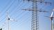 Wind turbines and power transmission lines shown side by side. Wind turbines and power transmission lines shown side by side.