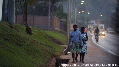 Two woman walk along a street in Kigali, Rwanda