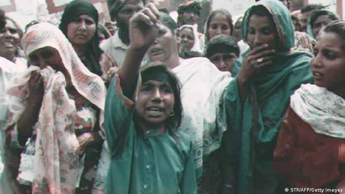 Color picture of women in sarees crying at a protest