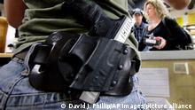 HOLD FOR MOVEMENT WITH STORY--Kayla Brown, left, wears her gun on her hip while working at the Spring Guns and Ammo store Monday, Jan. 4, 2016, in Spring, Texas. (AP Photo/David J. Phillip)