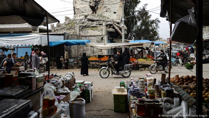 Syrians gather at a market as they prepare for the upcoming Muslim holy month of Ramadan, in the war-ravaged Syrian town of Ariha in the rebel-held northwestern Idlib province.
