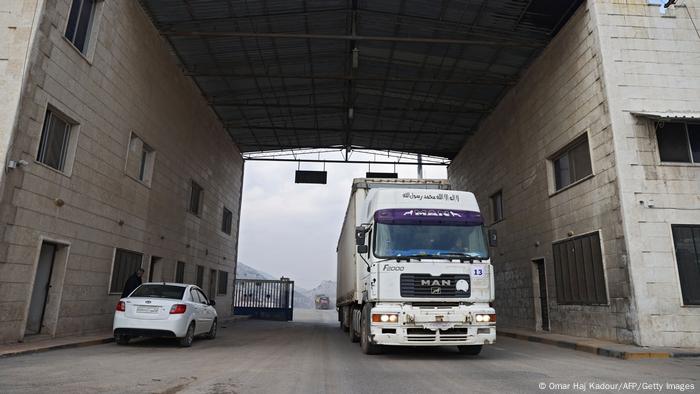 A convoy transporting humanitarian aid crosses into Syria from Turkey through the Bab al-Hawa border crossing.