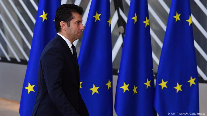 A man walking past EU flags