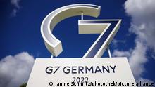 A sign installation that reads G7 Germany 2022 against a blue sky