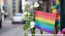 Flowers are left at the scene of a shooting in central Oslo