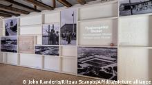 A wall shows photographs of the German refugee camp in the Danish town of Oksboel