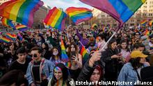 Spectators wave rainbow banners as they watch the annual Pride march in Santiago, Chile, Saturday, June 25, 2022. (AP Photo/Esteban Felix)