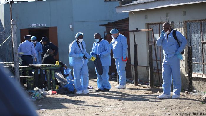 Forensic personnel investigate after the deaths of patrons found inside the Enyobeni Tavern