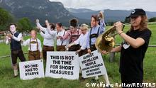 Activists of the NGO ONE, wearing masks depicting G7 leaders, protest against the G7 summit to be held in the nearby Bavarian alpine resort hotel Elmau Castle, outside the main G7 media centre, in Garmisch-Partenkirchen, Germany June 24, 2022. REUTERS/Wolfgang Rattay