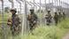India's Border Security Force (BSF) soldiers patrol along the border India's Border Security Force (BSF) soldiers patrol along the border