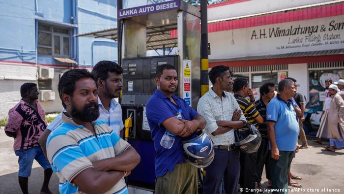 People wait to buy fuel at a fuel station in Colombo, Sri Lanka