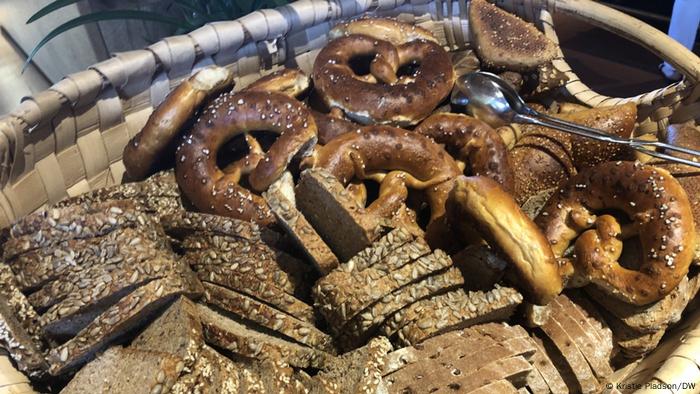 A basket of dark German bread and pretzels