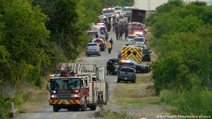 Police and fire fighters respond at the scene where 46 migrants were found dead inside a truck.