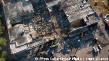 Ukrainian State Emergency Service firefighters work to take away debris at a shopping center burned after a rocket attack in Kremenchuk, Ukraine, Tuesday, June 28, 2022. (AP Photo/Efrem Lukatsky)