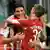 Gomez and a teammate hug after a goal