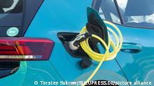 A charging cable is plugged in to an electric car