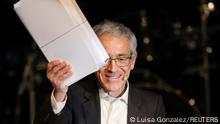 President of the Truth Commission Francisco de Roux holds the report of the Truth Commission, during the presentation of the final report of the commission, at the Jorge Eliecer Gaitan theater, in Bogota, Colombia June 28, 2022. REUTERS/Luisa Gonzalez