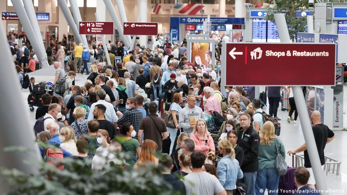 Crowds of holidaymakers wait in line at Dusseldorf airport