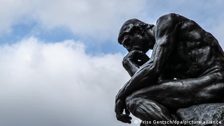 The Thinker: sculpture of a pensive man leaning his arm on his knee