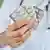 Mediziner im weißen Kittel hält Tabletten in der Hand 