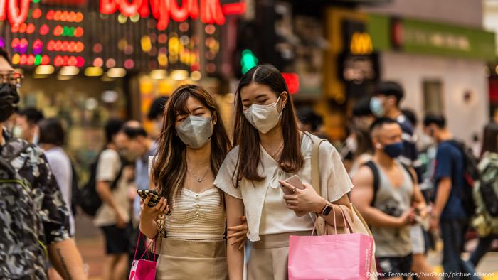 Two young Chinese women with shopping bags in Hong Kong