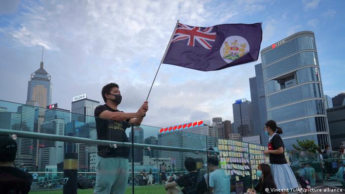 A man waving a Hong Kong British colony flag during a protest