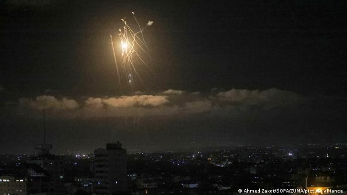 Streaks of light are seen as Israel's Iron Dome anti-missile system intercepts rockets launched from the Gaza Strip towards Israel.