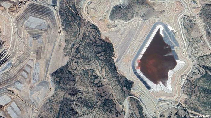 A satellite image of an open pit gold mine. A cyanide pool is visible.