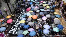 A banner which reads 'Democracy' (L) is carried during a protest march in Hong Kong on July 1, 2017, coinciding with the 20th anniversary of the city's handover from British to Chinese rule.
China's President Xi Jinping warned July 1 that any challenge to Beijing's control over Hong Kong crossed a red line, as thousands calling for more democracy marched through the city 20 years since it was handed back by Britain. / AFP PHOTO / Anthony WALLACE (Photo credit should read ANTHONY WALLACE/AFP via Getty Images)