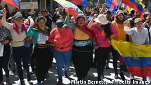 Indigenous demonstrators march in Quito on June 30, 2022, in the framework of indigenous-led protests against high living costs. - The Ecuadoran government said late on June 29 it would restart talks with indigenous-led protesters, mediated by the Catholic Church, as a fresh state of emergency was issued more than two weeks into disruptive and often violent daily rallies against rising living costs. (Photo by Martin BERNETTI / AFP) (Photo by MARTIN BERNETTI/AFP via Getty Images)