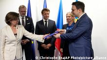 French Foreign Minister Catherine Colonna hands over a document to Czech Foreign Minister Jan Lipavsky during the EU presidency hand over ceremony