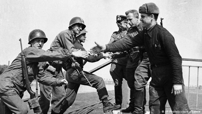 US and Russian forces meet on wrecked bridge over Elbe River in Torgau