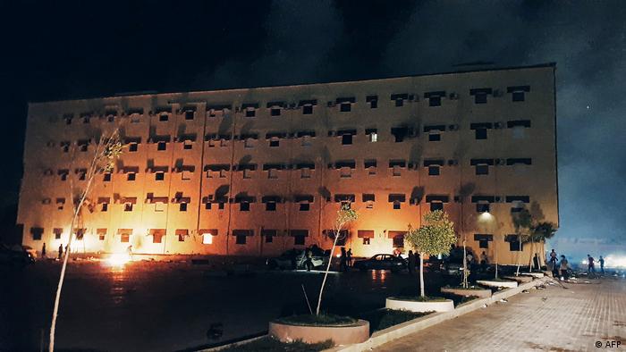 Building lit up by protesters while demonstrating against deteriorating living conditions