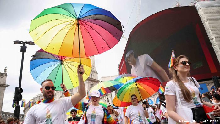 People hold rainbow colored umbrellas during the 2022 Pride Parade in London, Britain July 2, 2022.