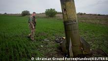 FILE PHOTO: A Ukrainian serviceman walks next to remains of a Russian Tochka U ballistic missile, as Russia's attack on Ukraine continues, in Kharkiv region, Ukraine, in this handout picture released April 23, 2022. To match Special Report UKRAINE-CRISIS/ARMS-SANCTIONS Press service of the Ukrainian Ground Forces/Handout via REUTERS THIS IMAGE HAS BEEN SUPPLIED BY A THIRD PARTY./File Photo