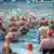 Swimmers with orange bathing caps in the Baltic See