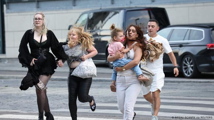 People leave Field's shopping center, after reports of a shooting, in Copenhagen, Denmark, July 3, 2022