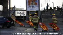 Emergency personnel carry stretchers at Fields shopping center, after Danish police said they received reports of a shooting at the site, in Copenhagen, Denmark, July 3, 2022. Ritzau Scanpix/Olafur Steinar Gestsson via REUTERS ATTENTION EDITORS - THIS IMAGE WAS PROVIDED BY A THIRD PARTY. DENMARK OUT. NO COMMERCIAL OR EDITORIAL SALES IN DENMARK.