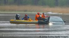 SYDNEY, AUSTRALIA - JULY 04: A man is rescued from his car by State Emergency Service workers in Windsor on July 04, 2022 in Sydney, Australia. Thousands of residents were forced to leave their homes overnight and a number of evacuation orders are in place across Sydney as heavy rain and flooding continues. (Photo by Jenny Evans/Getty Images)