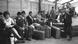 Group of men and one women. The men have suitcases in front of them. One is carrying a sign with Istanbul on it. Group of men and one women. The men have suitcases in front of them. One is carrying a sign with Istanbul on it.