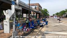 Empty chairs sit along the sidewalk after parade-goers fled Highland Park's Fourth of July parade after shots were fired, Monday, July 4, 2022 in Chicago. (Lynn Sweet/Chicago Sun-Times via AP)