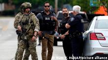 Law enforcement search after a mass shooting at the Highland Park Fourth of July parade in downtown Highland Park, a Chicago suburb on Monday, July 4, 2022. (AP Photo/Nam Y. Huh)