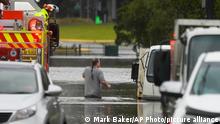A man walks through flood waters back to his home from a fire truck at Windsor on the outskirts of Sydney, Australia, Tuesday, July 5, 2022. Hundreds of homes have been inundated in and around Australiaâ€™s largest city in a flood emergency that was threatening 50,000 people, officials said on Tuesday. (AP Photo/Mark Baker)