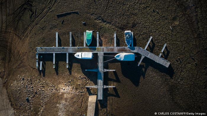 An aerial view of boats resting on dry land where there once were water at Ribeira de Alge