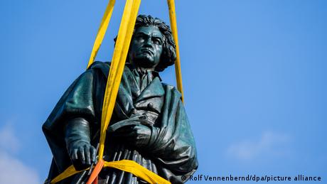 Beethoven statue being transported with yellow harness