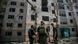 Soldiers stand outside a shelled building Soldiers stand outside a shelled building